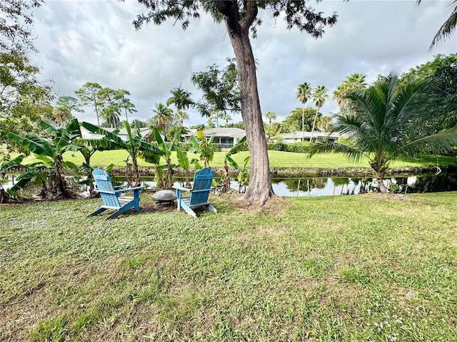 view of yard featuring a water view and a fire pit