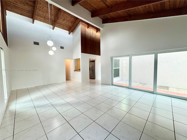 spare room featuring beam ceiling, light tile patterned floors, high vaulted ceiling, and wooden ceiling