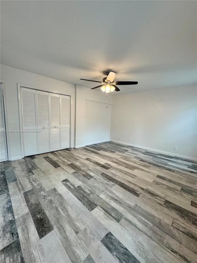 unfurnished bedroom with wood-type flooring and ceiling fan