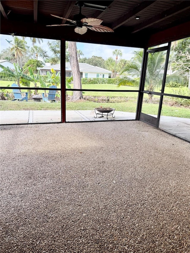 unfurnished sunroom with ceiling fan