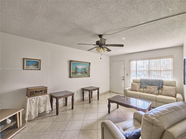 tiled living room with a textured ceiling and ceiling fan