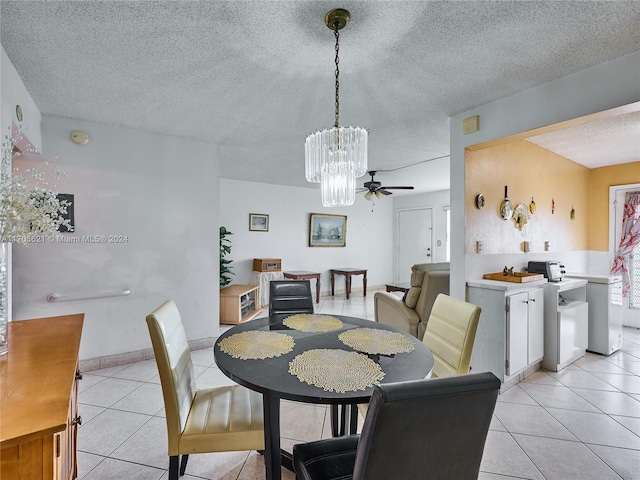 dining room featuring ceiling fan, light tile patterned floors, and a textured ceiling