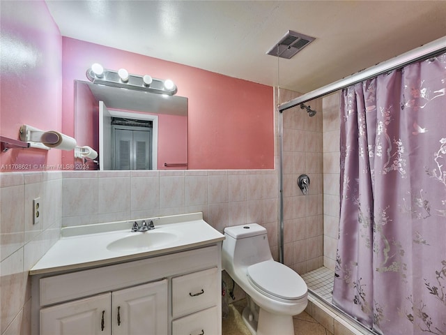 bathroom featuring toilet, vanity, tile walls, and walk in shower