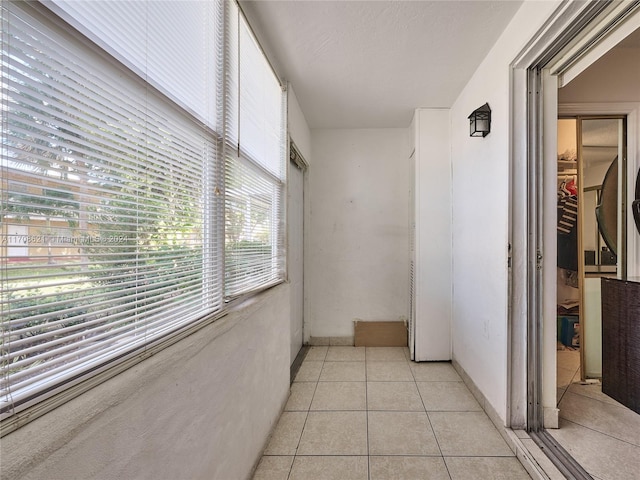 corridor featuring light tile patterned flooring