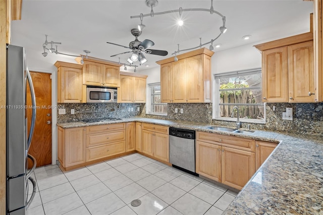 kitchen with appliances with stainless steel finishes, light brown cabinets, and sink