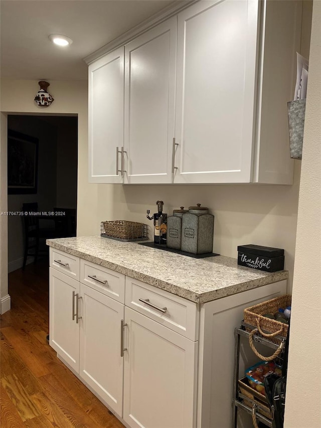 kitchen with white cabinetry and light hardwood / wood-style flooring