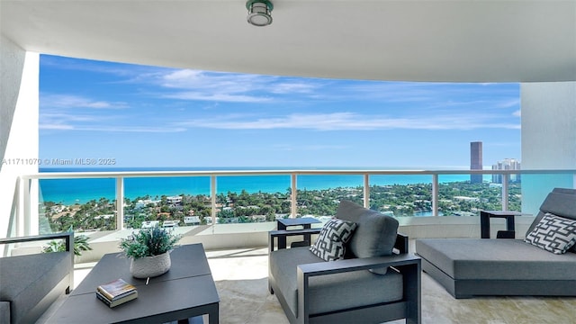 balcony with a water view and an outdoor living space