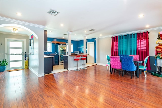 dining space with crown molding and hardwood / wood-style flooring