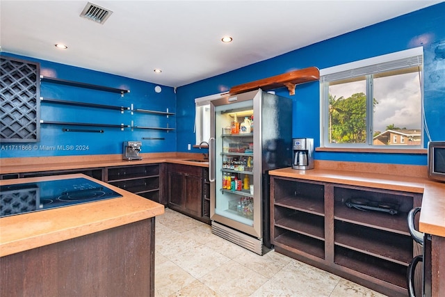 bar with black electric cooktop and sink