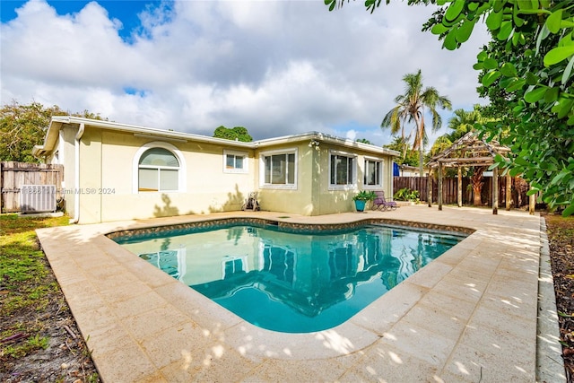 view of swimming pool with a gazebo, central AC unit, and a patio area