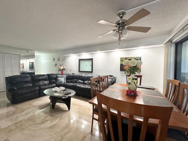 dining area with ceiling fan and a textured ceiling