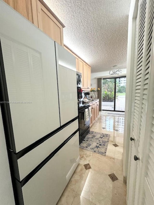 kitchen with white fridge, light brown cabinets, black range with electric stovetop, and a textured ceiling