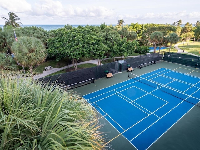 view of sport court with a water view