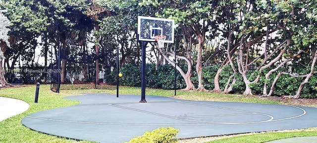 view of sport court featuring a yard