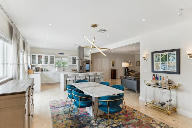 tiled dining space featuring plenty of natural light and sink