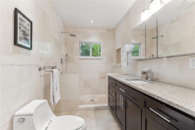 bathroom featuring tiled shower, tile walls, and a wealth of natural light