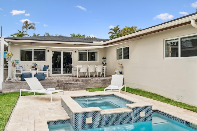 rear view of house featuring a swimming pool with hot tub and a patio area