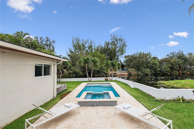 view of swimming pool featuring a lawn, a water view, and a patio