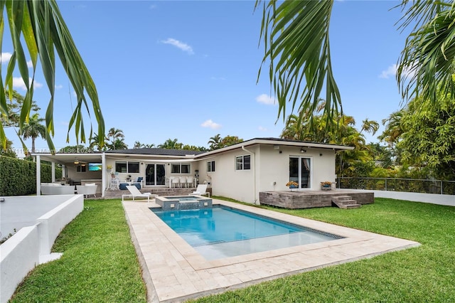 back of house with exterior bar, ceiling fan, a swimming pool with hot tub, a patio area, and a yard