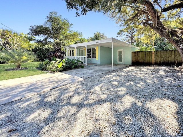 1820 SW 11th Ct, Fort Lauderdale, FL 33312 - view of front of house with driveway, covered porch, and an attached carport