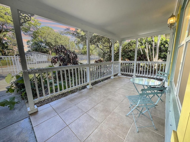 patio terrace at dusk featuring a porch