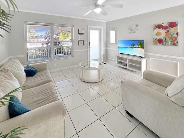 living room featuring tile patterned floors, ceiling fan, and crown molding