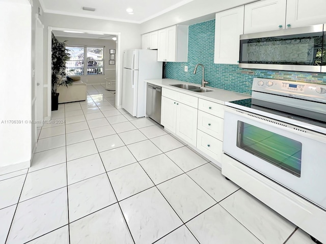 kitchen featuring white cabinets, sink, ornamental molding, tasteful backsplash, and stainless steel appliances