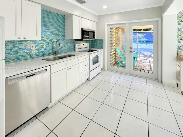 1820 SW 11th Ct, Fort Lauderdale, FL 33312 - kitchen with stainless steel appliances, light countertops, decorative backsplash, french doors, and white cabinets