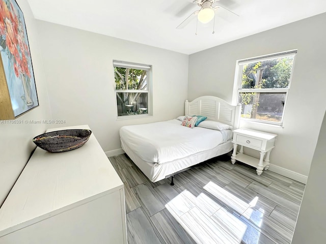 bedroom with multiple windows and ceiling fan