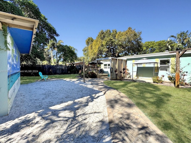 view of yard with a gazebo, a patio area, and a wooden deck