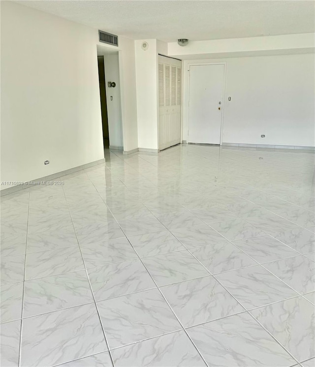 empty room featuring a textured ceiling