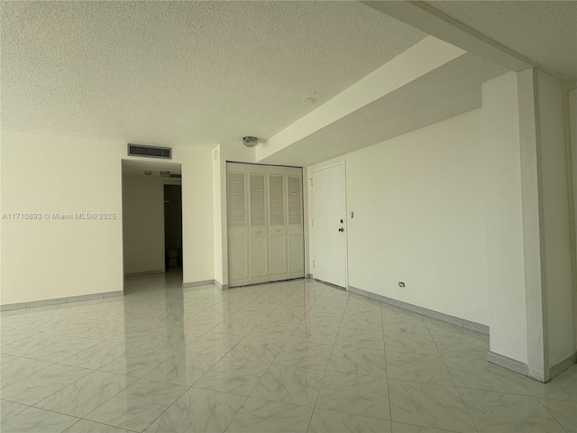 empty room featuring a textured ceiling