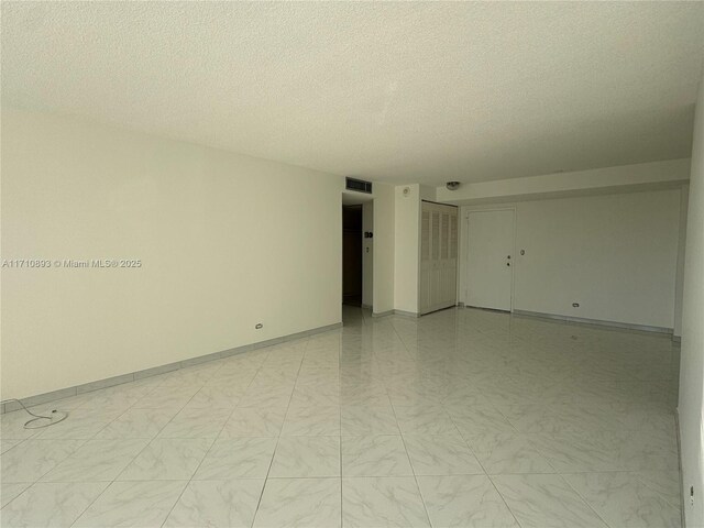 empty room with a textured ceiling