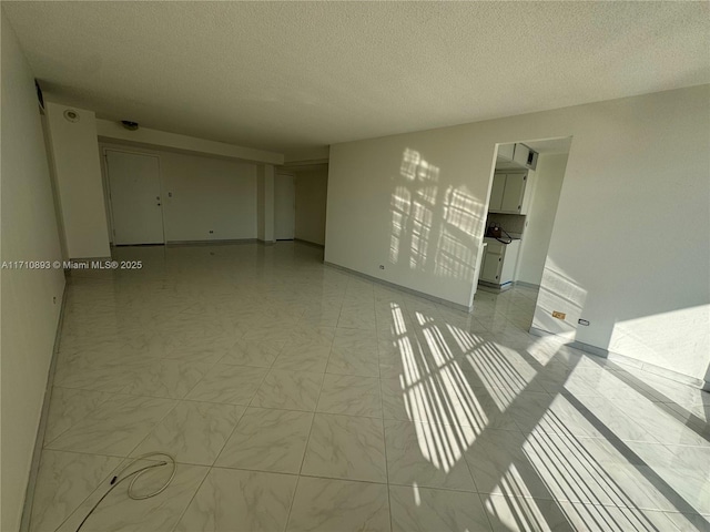 spare room with a textured ceiling