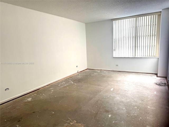 spare room with a textured ceiling