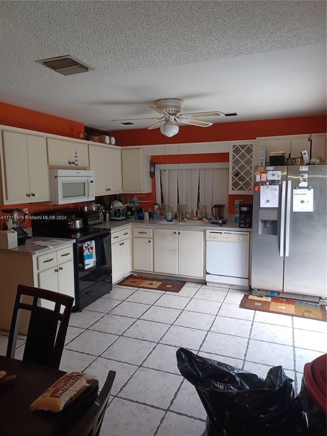 kitchen featuring white appliances, white cabinets, ceiling fan, a textured ceiling, and light tile patterned flooring