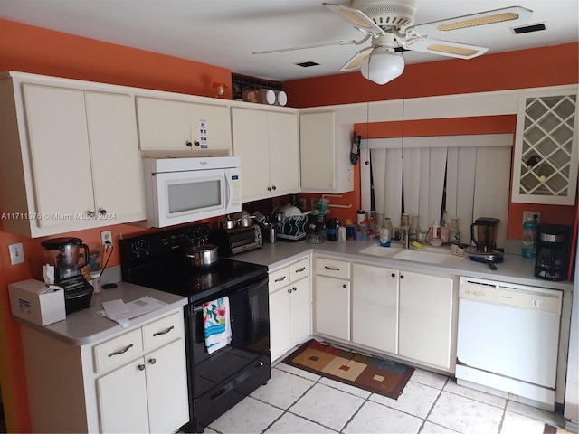 kitchen featuring white cabinetry and white appliances