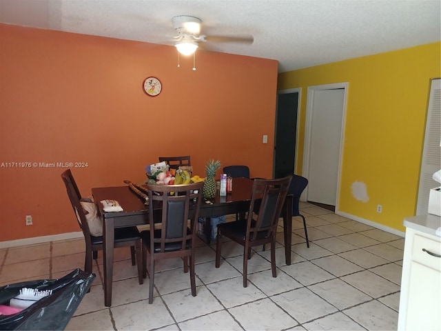 dining space featuring ceiling fan and light tile patterned floors