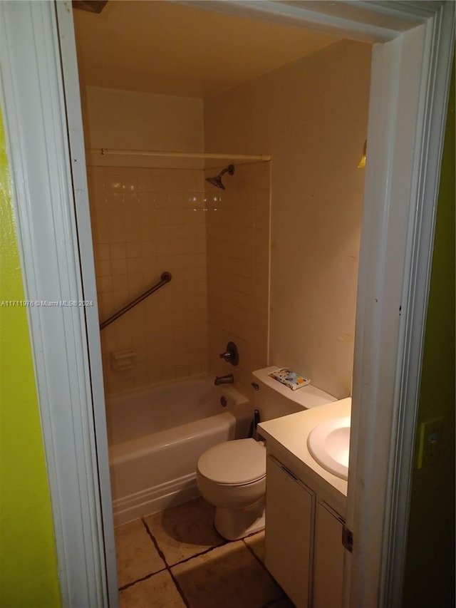 full bathroom featuring tile patterned flooring, tiled shower / bath combo, toilet, and vanity