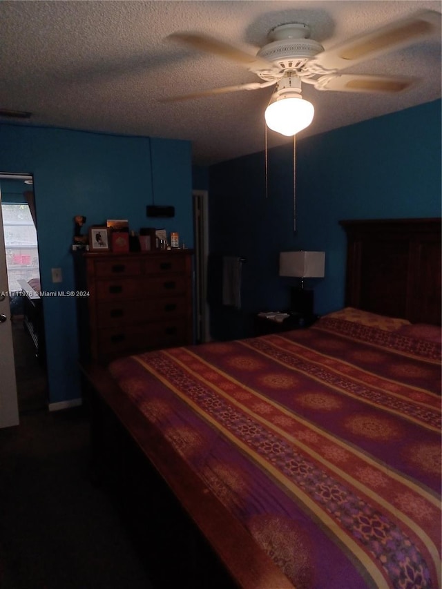 bedroom with a textured ceiling and ceiling fan