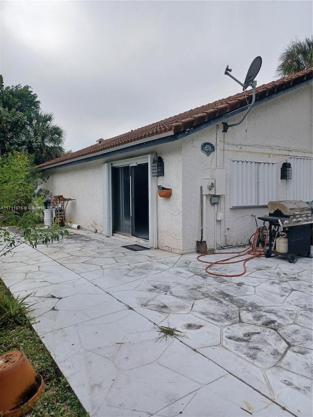 rear view of property featuring a patio