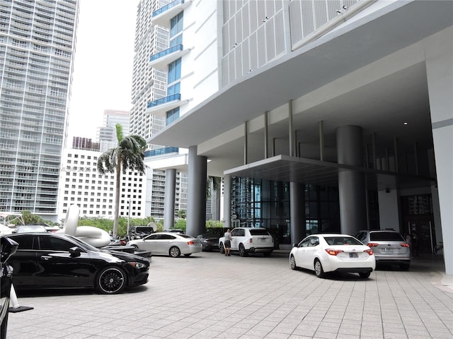 view of car parking with a view of city