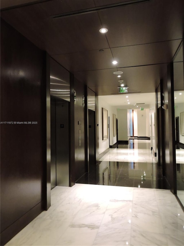 hallway featuring marble finish floor