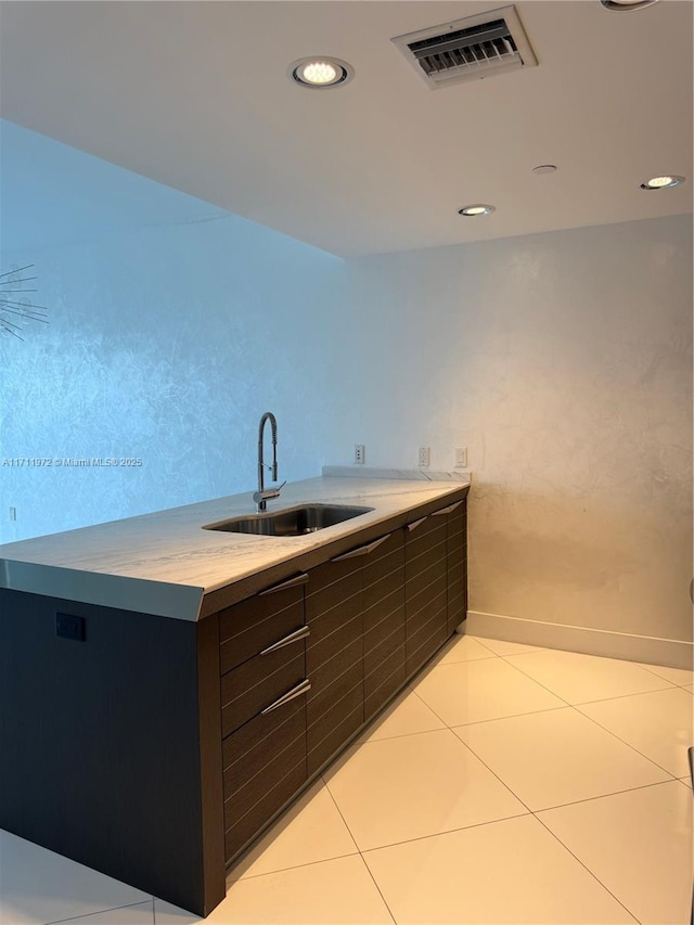 kitchen with light tile patterned floors, visible vents, light countertops, a sink, and recessed lighting