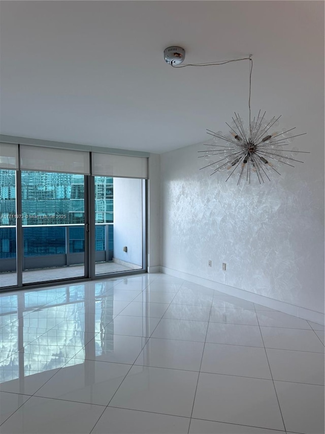 empty room featuring tile patterned flooring and a textured wall