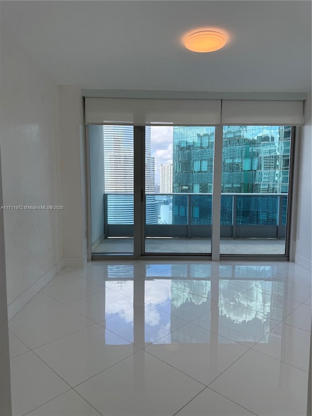 tiled spare room featuring a view of city