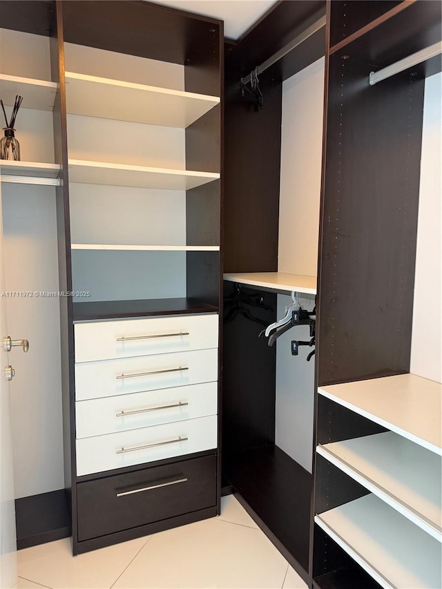 spacious closet with light tile patterned floors