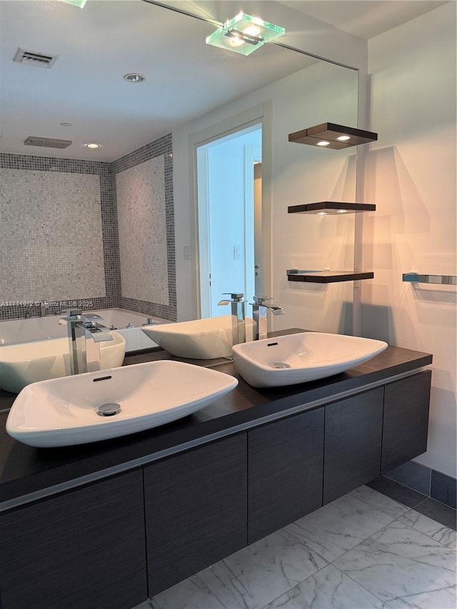 bathroom featuring double vanity, marble finish floor, visible vents, and a sink