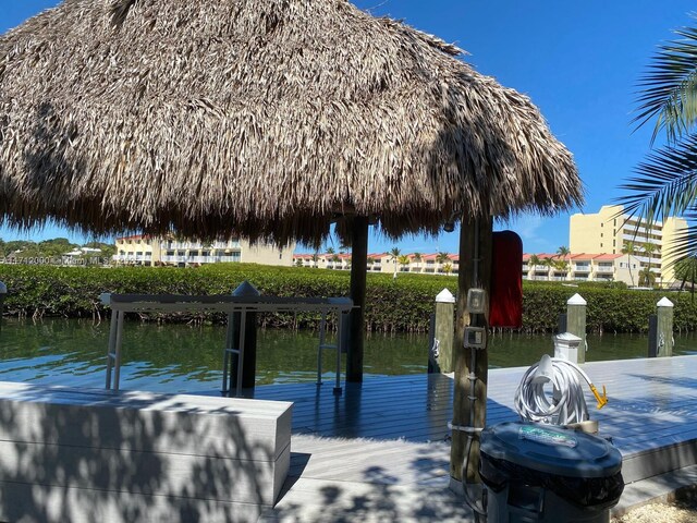 view of dock featuring a gazebo and a water view