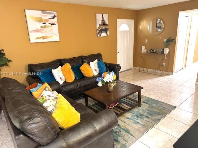 living room with light tile patterned floors